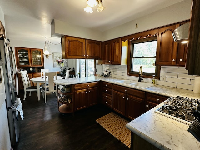 937 Alles Dr SW, Byron Center, MI 49315 - kitchen with plenty of natural light, tasteful backsplash, a peninsula, and dark wood-style floors