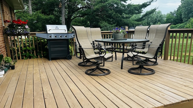 937 Alles Dr SW, Byron Center, MI 49315 - deck with outdoor dining area, area for grilling, and view of wooded area