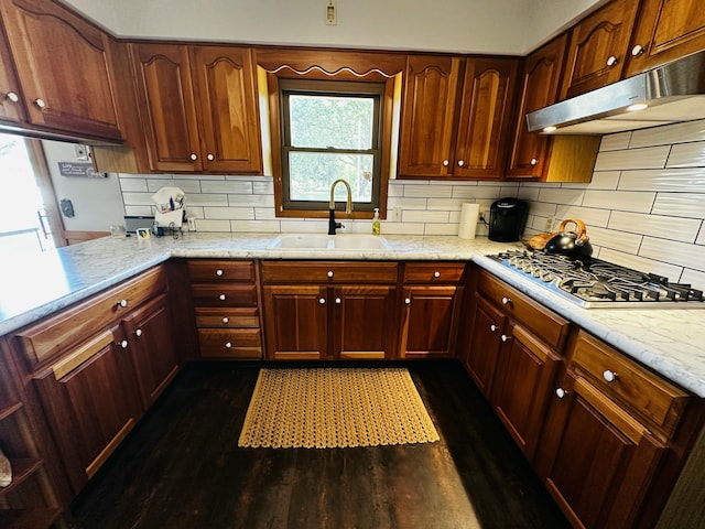 937 Alles Dr SW, Byron Center, MI 49315 - kitchen featuring tasteful backsplash, under cabinet range hood, stainless steel gas stovetop, and dark wood-style floors
