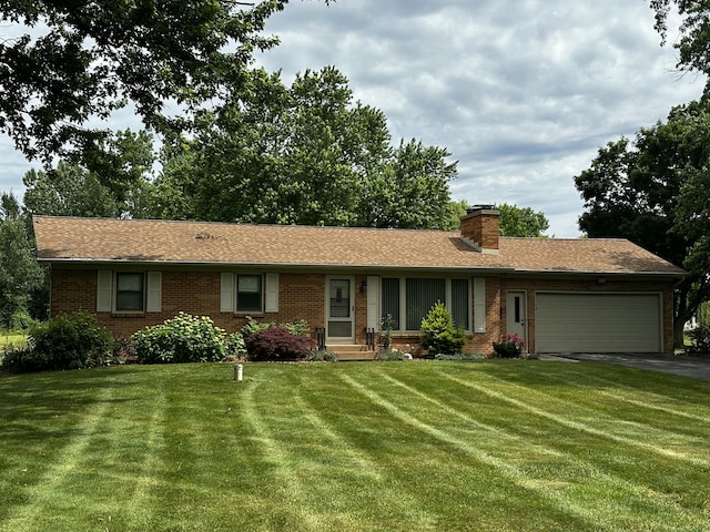 937 Alles Dr SW, Byron Center, MI 49315 - ranch-style home featuring an attached garage, driveway, brick siding, and a front yard