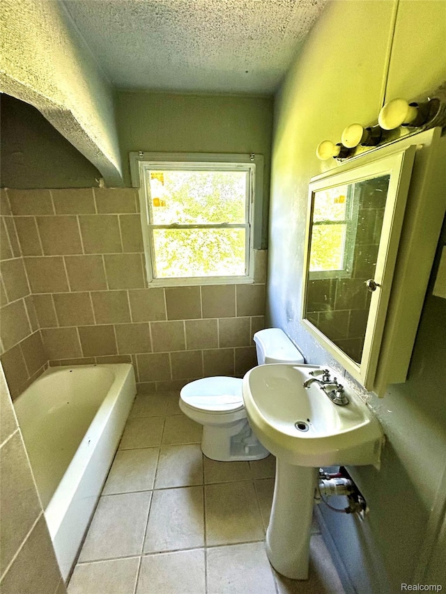 14869 Mark Twain St, Detroit, MI 48227 - full bath with a tub, tile patterned flooring, a textured ceiling, and tile walls