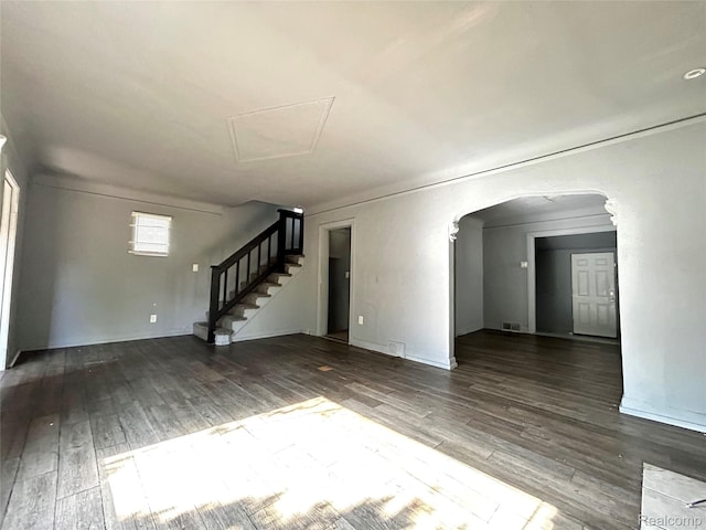 14869 Mark Twain St, Detroit, MI 48227 - unfurnished living room with wood finished floors, arched walkways, and stairway