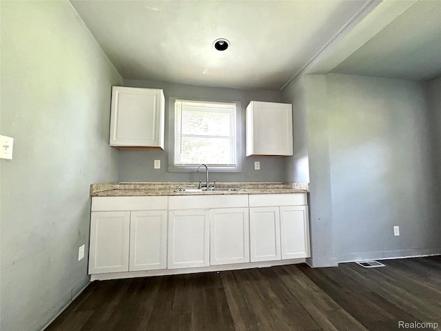 14869 Mark Twain St, Detroit, MI 48227 - kitchen featuring dark wood-style floors and white cabinetry