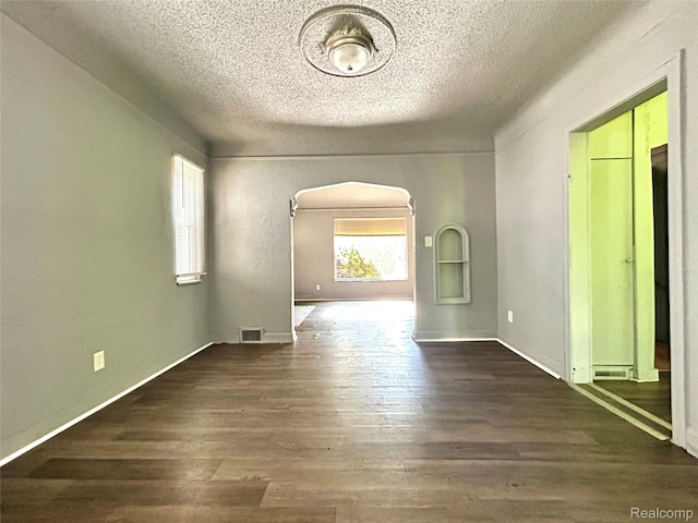 14869 Mark Twain St, Detroit, MI 48227 - empty room featuring a textured ceiling, wood finished floors, and arched walkways