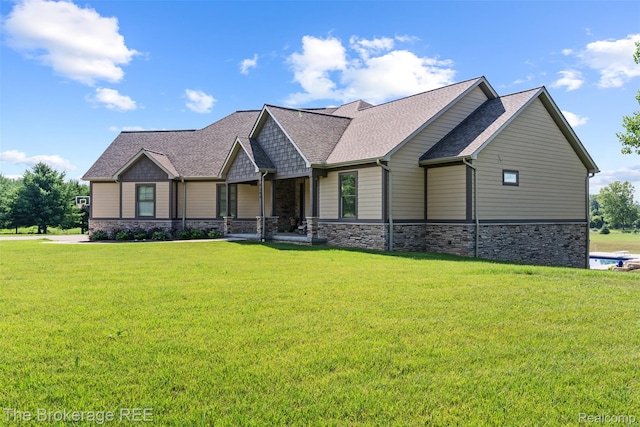 6264 Hidden Forrest, Swartz Creek, MI 48473 - craftsman-style house with stone siding, roof with shingles, and a front lawn