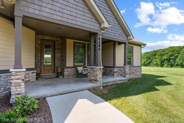 6264 Hidden Forrest, Swartz Creek, MI 48473 - entrance to property featuring stone siding, covered porch, and a lawn