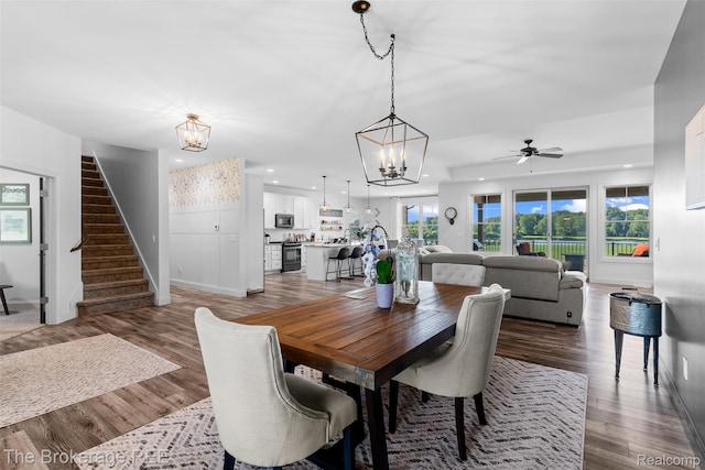 6264 Hidden Forrest, Swartz Creek, MI 48473 - dining space featuring a chandelier, stairway, plenty of natural light, wood finished floors, and recessed lighting