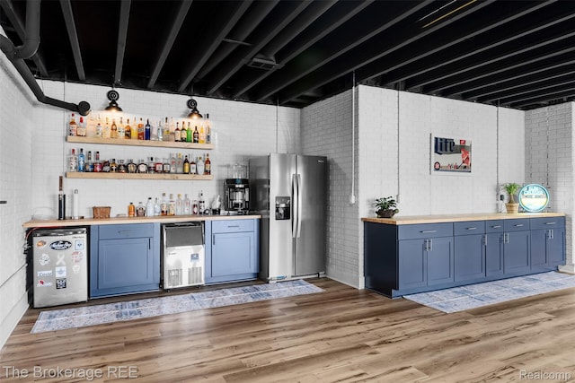 6264 Hidden Forrest, Swartz Creek, MI 48473 - indoor dry bar featuring stainless steel fridge, fridge, light wood-style flooring, and brick wall