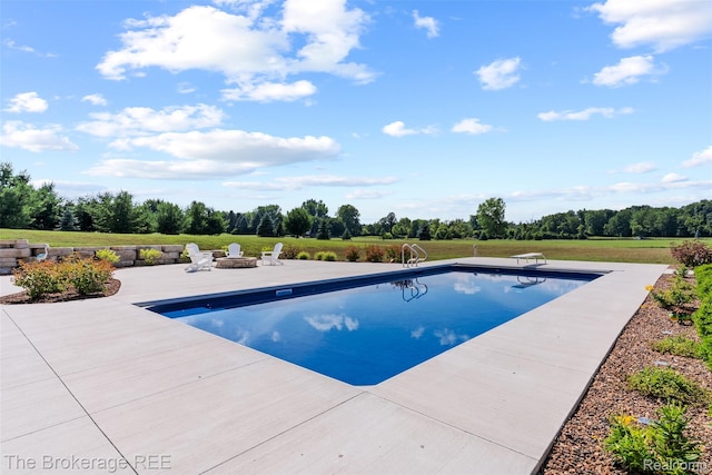 6264 Hidden Forrest, Swartz Creek, MI 48473 - swimming pool featuring a patio, an outdoor fire pit, a diving board, and view of scattered trees