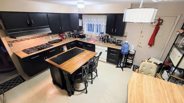 28740 Tavistock Trl, Southfield, MI 48034 - kitchen featuring dark cabinets, white dishwasher, gas cooktop, and wooden counters
