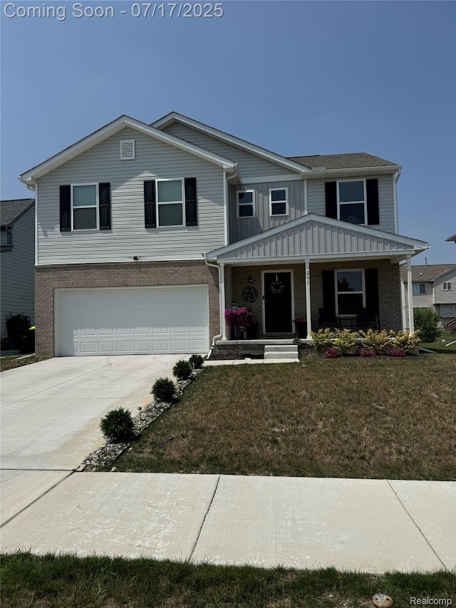 291 Samburu St, Pontiac, MI 48341 - traditional-style house with a garage, board and batten siding, concrete driveway, a front yard, and a porch