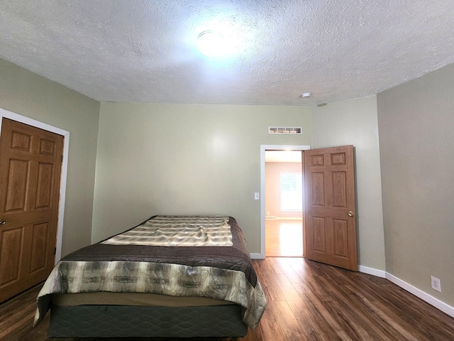 6580 Deerfield Trl, Lake, MI 48632 - bedroom with wood finished floors and a textured ceiling