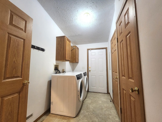 6580 Deerfield Trl, Lake, MI 48632 - washroom featuring a textured ceiling, cabinet space, and washing machine and clothes dryer