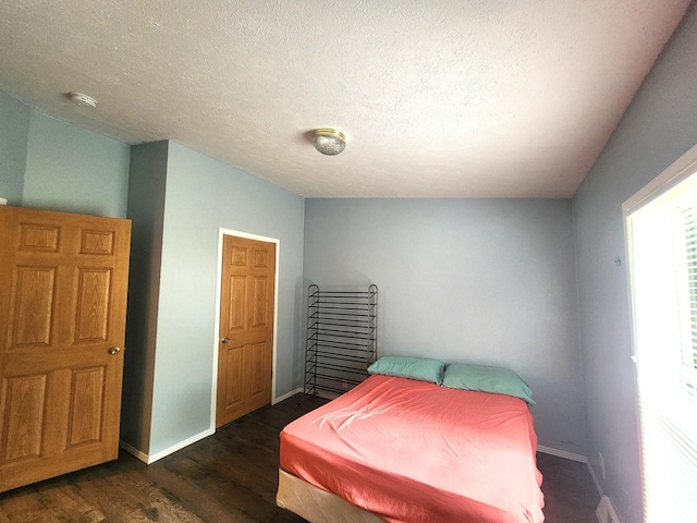 6580 Deerfield Trl, Lake, MI 48632 - bedroom featuring dark wood-style floors and a textured ceiling
