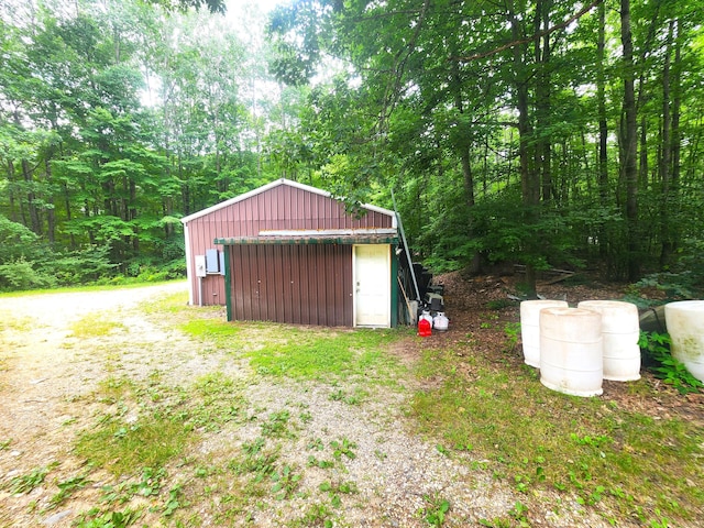6580 Deerfield Trl, Lake, MI 48632 - view of yard with a detached garage, an outdoor structure, and a forest view