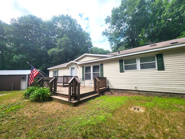 6580 Deerfield Trl, Lake, MI 48632 - rear view of house with a deck and a lawn