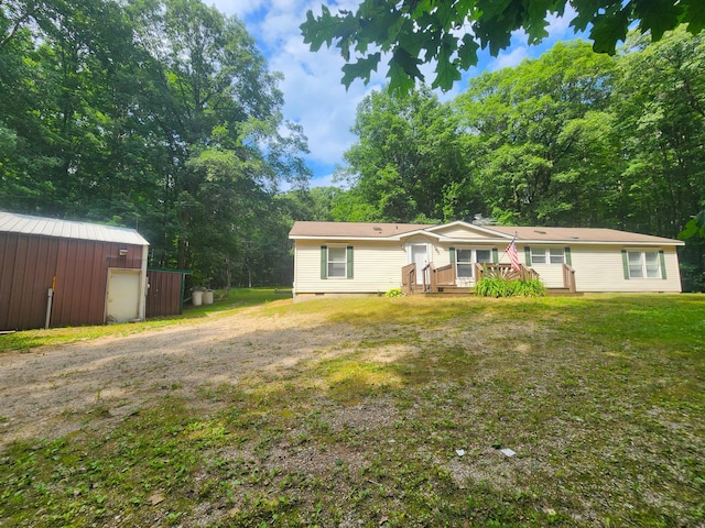 6580 Deerfield Trl, Lake, MI 48632 - view of front of home featuring crawl space, a front yard, an outdoor structure, and a deck