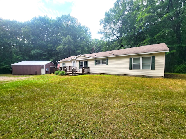 6580 Deerfield Trl, Lake, MI 48632 - rear view of property with crawl space, a wooden deck, a yard, and an outbuilding