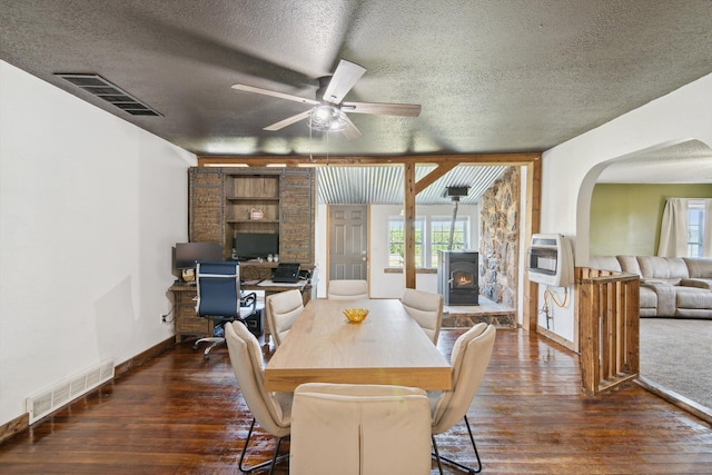1903 Bucholtz Hwy, Deerfield, MI 49238 - dining space featuring a textured ceiling, hardwood / wood-style floors, arched walkways, a ceiling fan, and heating unit