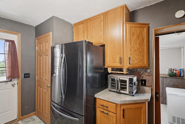 1903 Bucholtz Hwy, Deerfield, MI 49238 - kitchen with freestanding refrigerator, light countertops, fridge, and a textured ceiling
