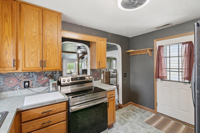 1903 Bucholtz Hwy, Deerfield, MI 49238 - kitchen with appliances with stainless steel finishes, arched walkways, light countertops, a textured ceiling, and a ceiling fan