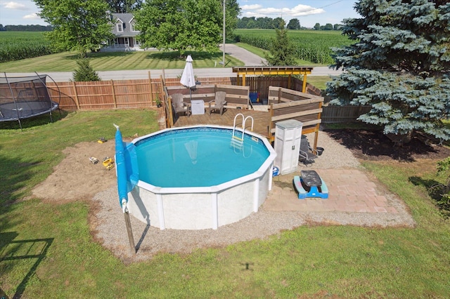 1903 Bucholtz Hwy, Deerfield, MI 49238 - view of swimming pool featuring a trampoline, a fenced backyard, agricultural plots, and a patio