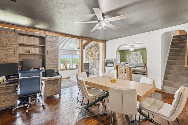 1903 Bucholtz Hwy, Deerfield, MI 49238 - dining space featuring ceiling fan, a textured ceiling, dark wood-type flooring, stairs, and arched walkways
