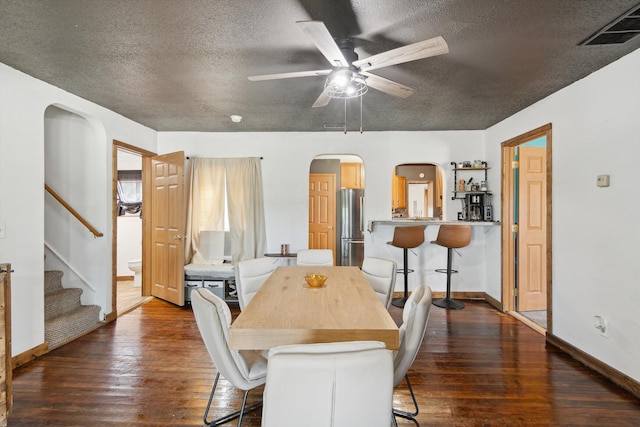 1903 Bucholtz Hwy, Deerfield, MI 49238 - dining area featuring arched walkways, a textured ceiling, a ceiling fan, dark wood-style floors, and stairway