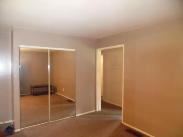 951-955 Bellevue Ave St, Jackson, MI 49202 - unfurnished bedroom featuring a closet and carpet flooring