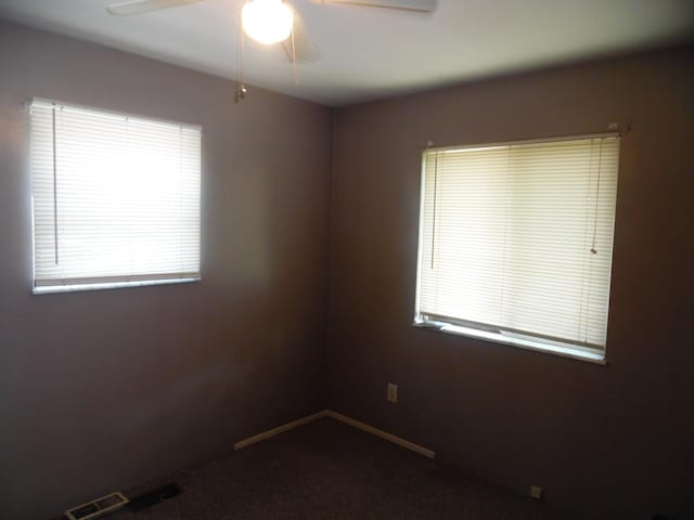 951-955 Bellevue Ave St, Jackson, MI 49202 - unfurnished room featuring ceiling fan, healthy amount of natural light, and dark carpet