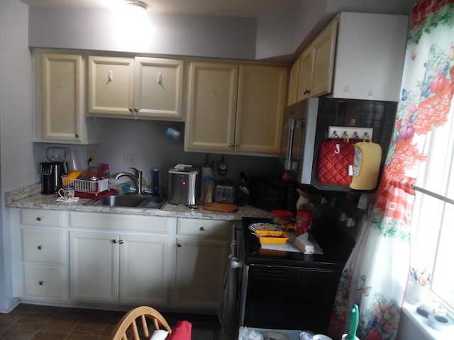 951-955 Bellevue Ave St, Jackson, MI 49202 - kitchen featuring light countertops, black / electric stove, and tile patterned floors
