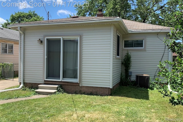 6455 Mayfair St, Taylor, MI 48180 - view of property exterior featuring a lawn, a chimney, entry steps, and a shingled roof