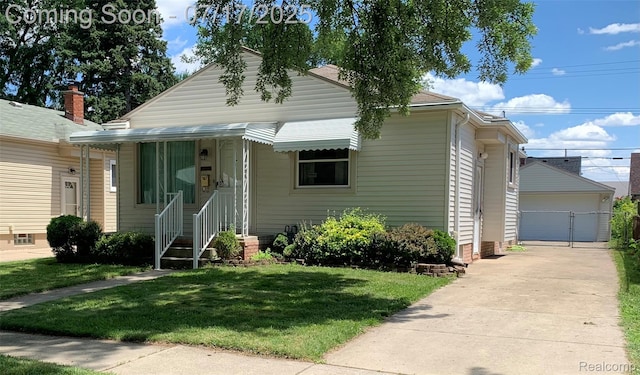 6455 Mayfair St, Taylor, MI 48180 - view of front of house with a front lawn, an outbuilding, and a detached garage