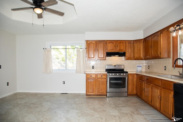 25095 Darin St, Taylor, MI 48180 - kitchen with stainless steel range with gas cooktop, brown cabinetry, light countertops, and a textured ceiling