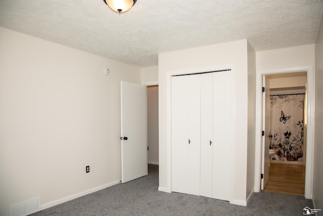 25095 Darin St, Taylor, MI 48180 - unfurnished bedroom featuring a closet, carpet, and a textured ceiling