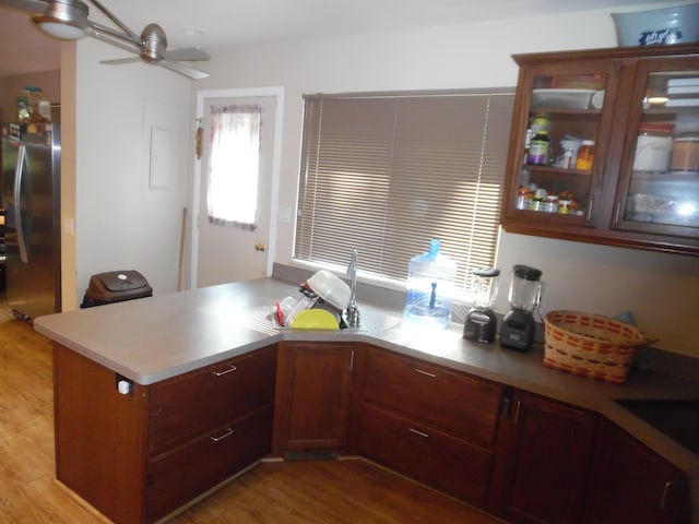 954 Concord Blvd, Jackson, MI 49202 - kitchen featuring freestanding refrigerator, a ceiling fan, light countertops, a peninsula, and light wood-type flooring