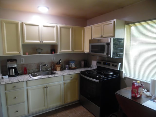 954 Concord Blvd, Jackson, MI 49202 - kitchen featuring stainless steel appliances, open shelves, and healthy amount of natural light