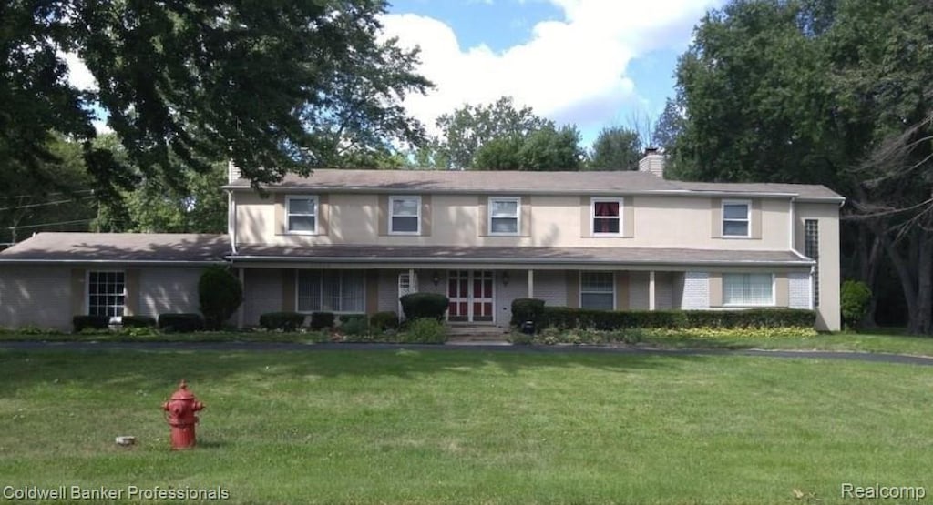 29585 Woodhaven Ln, Southfield, MI 48076 - traditional home featuring a front yard and a chimney