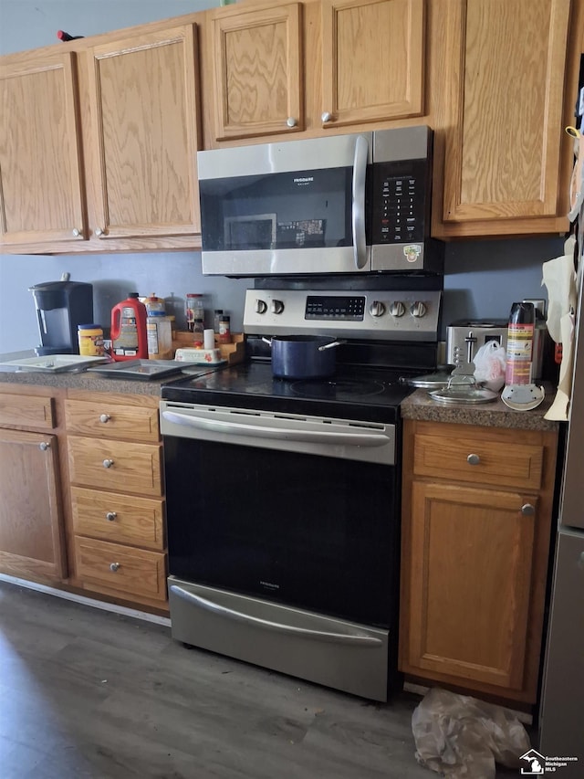 3017 3rd St, Monroe, MI 48162 - kitchen with appliances with stainless steel finishes, dark wood-type flooring, and dark countertops