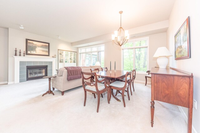 827 Asa Gray Dr Unit 257, Ann Arbor, MI 48105 - dining area with light colored carpet, a chandelier, and a tiled fireplace