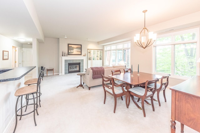 827 Asa Gray Dr Unit 257, Ann Arbor, MI 48105 - dining area with a chandelier, light colored carpet, and a tile fireplace