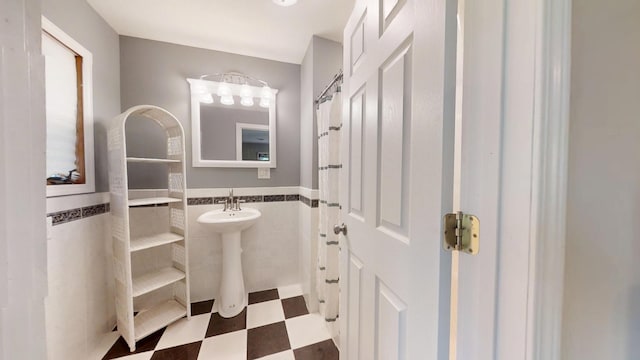 16035 Walnut St, Buchanan, MI 49107 - bathroom featuring tile walls, tile patterned floors, and a wainscoted wall
