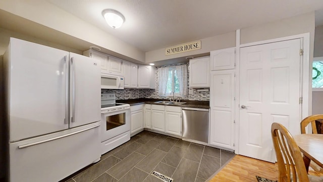16035 Walnut St, Buchanan, MI 49107 - kitchen with white appliances, dark countertops, white cabinets, and tasteful backsplash