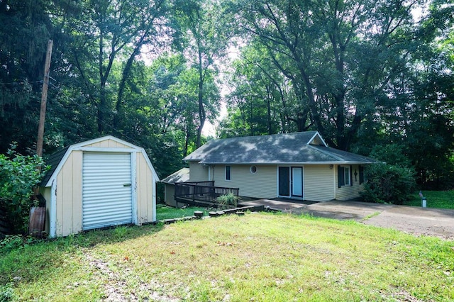 16035 Walnut St, Buchanan, MI 49107 - view of front of home with a storage shed, a wooden deck, and a front lawn