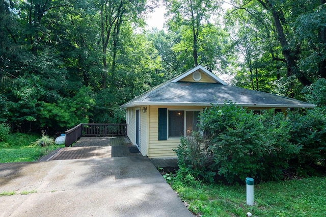 16035 Walnut St, Buchanan, MI 49107 - view of front facade with roof with shingles, driveway, and a wooded view