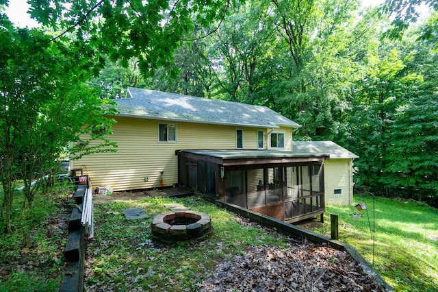 16035 Walnut St, Buchanan, MI 49107 - rear view of house with a sunroom, a fire pit, and a yard