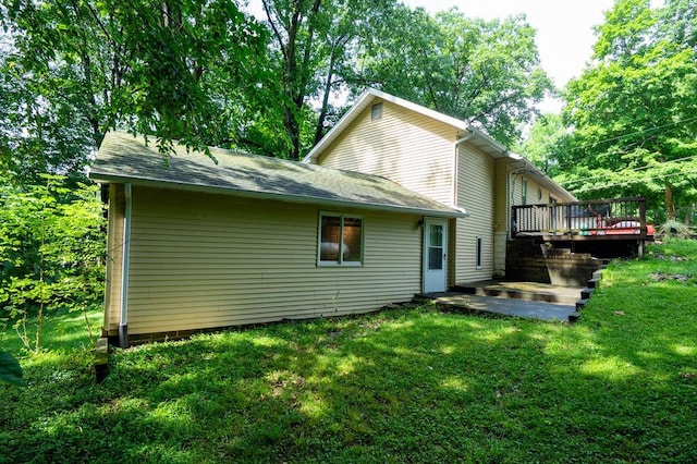 16035 Walnut St, Buchanan, MI 49107 - rear view of house with a deck, a lawn, and a shingled roof