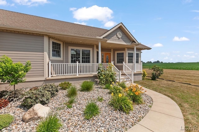 5726 Wolf Creek Hwy, Adrian, MI 49221 - view of front of property with a porch, a shingled roof, and a front lawn