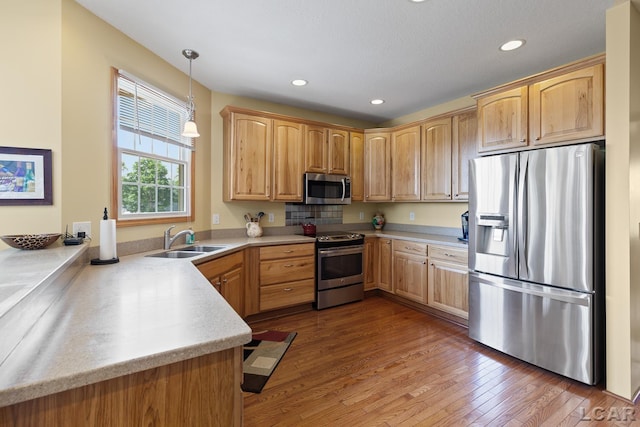 5726 Wolf Creek Hwy, Adrian, MI 49221 - kitchen featuring stainless steel appliances, light countertops, wood finished floors, decorative light fixtures, and recessed lighting
