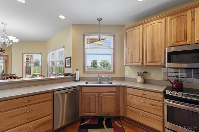 5726 Wolf Creek Hwy, Adrian, MI 49221 - kitchen with stainless steel appliances, plenty of natural light, hanging light fixtures, a chandelier, and recessed lighting